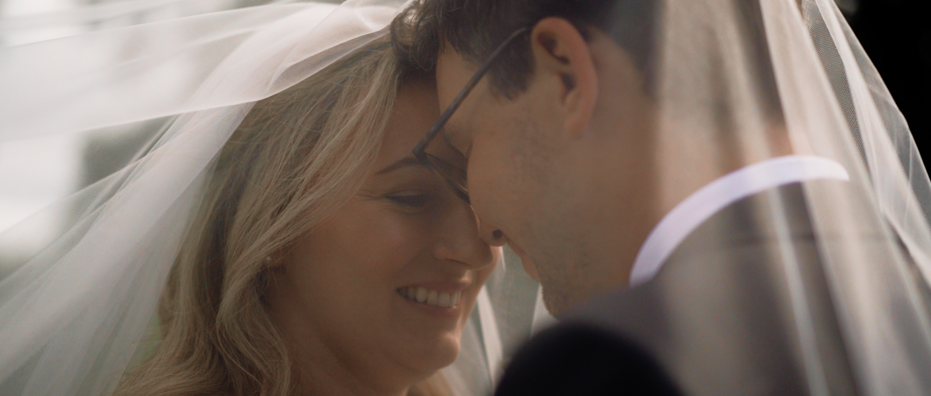 Alice and Alice share a private moment under a veil